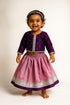 Girl wearing silk cotton festive dress with traditional Indian design