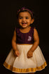 Girl wearing traditional Kerala set mundu cotton dress for Onam